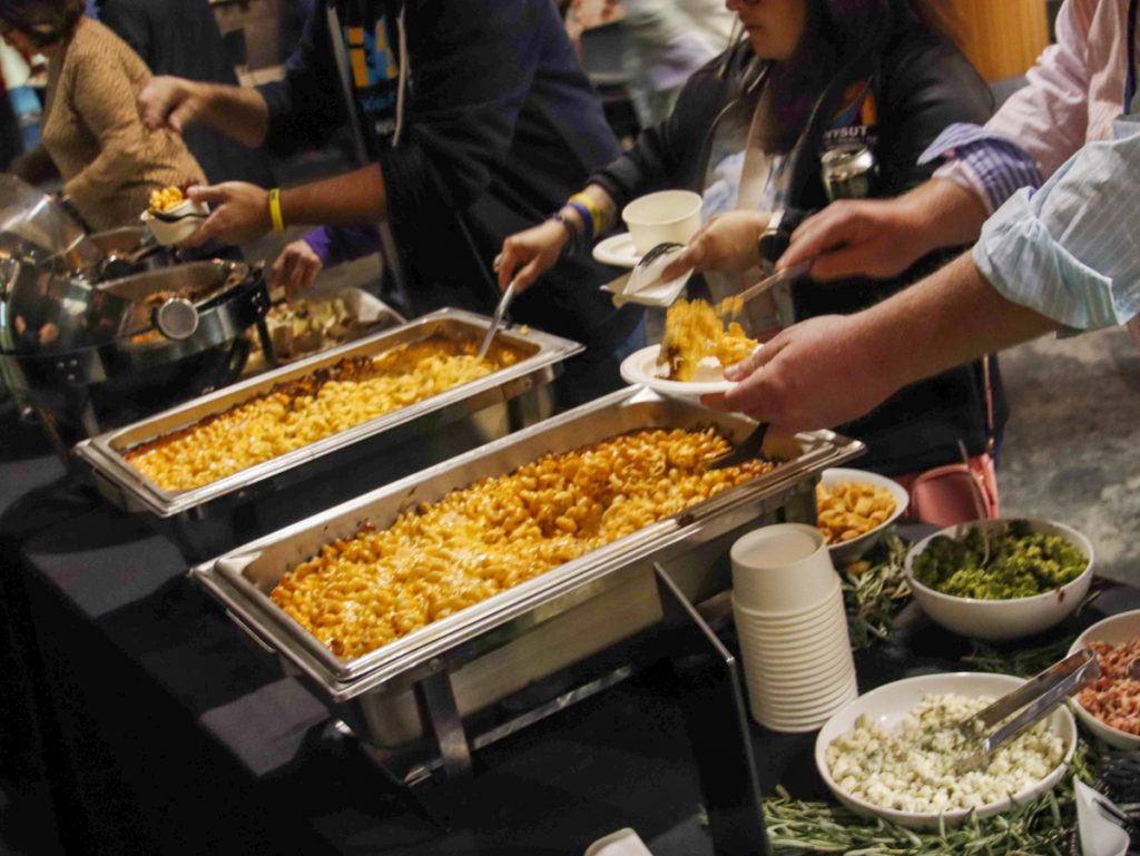 NYSUT educators help themselves to mac and cheese and salads.