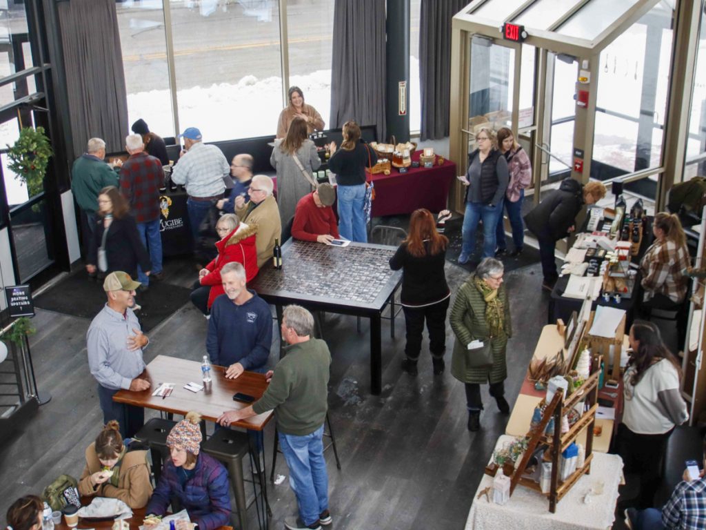 Guests browsing tasting tables during our Indoor Winter Wine Tour in a downtown Rochester event space